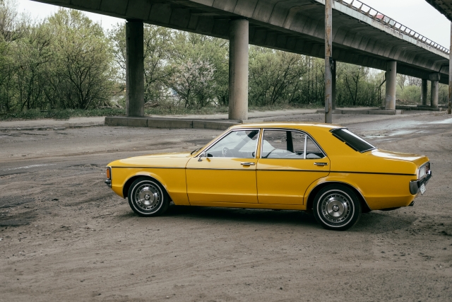 yellow classic car under the bridge thumbs